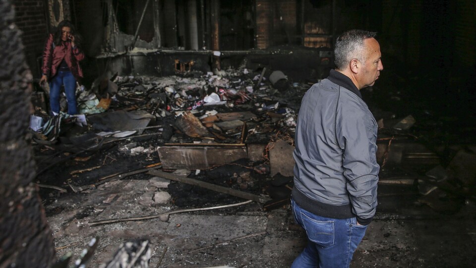 Un homme se tient dans les ruines du journal El Mercurio, au Chili, dont le siège a été détruit par un incendie. 