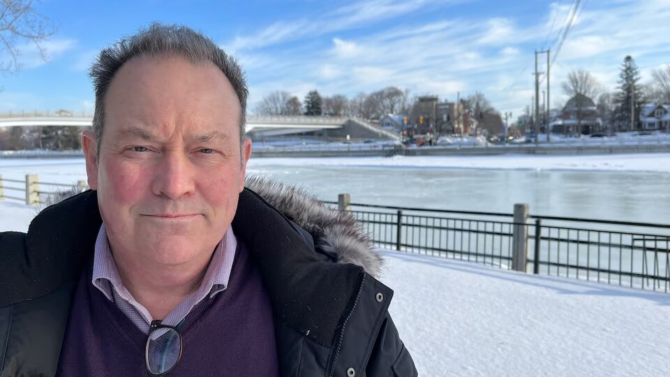 Christopher Burke devant le canal Rideau, en hiver.