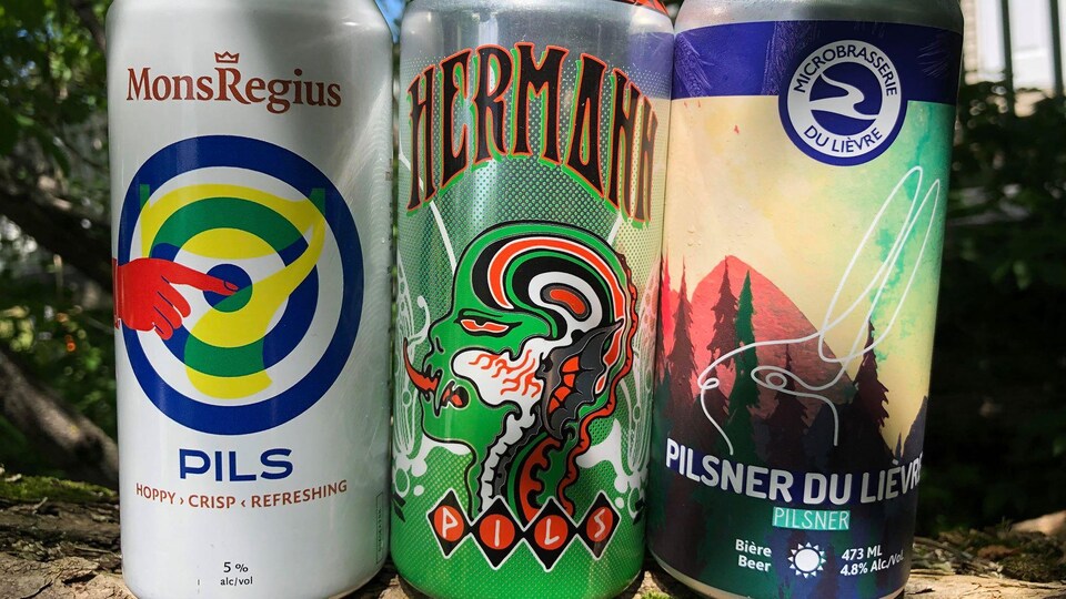 Trois cannettes de bière côte à côte.