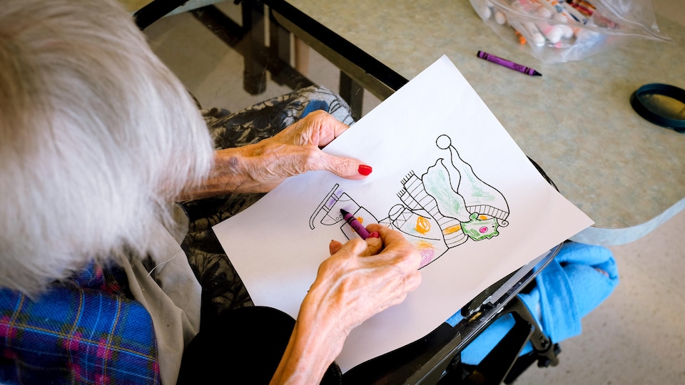 An elderly woman coloring a skating child.