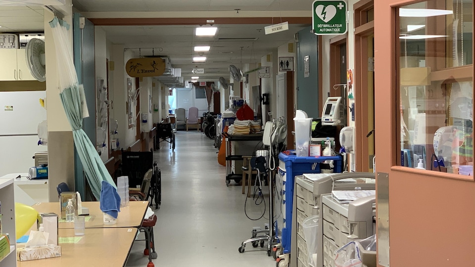 A corridor with a lot of medical equipment.
