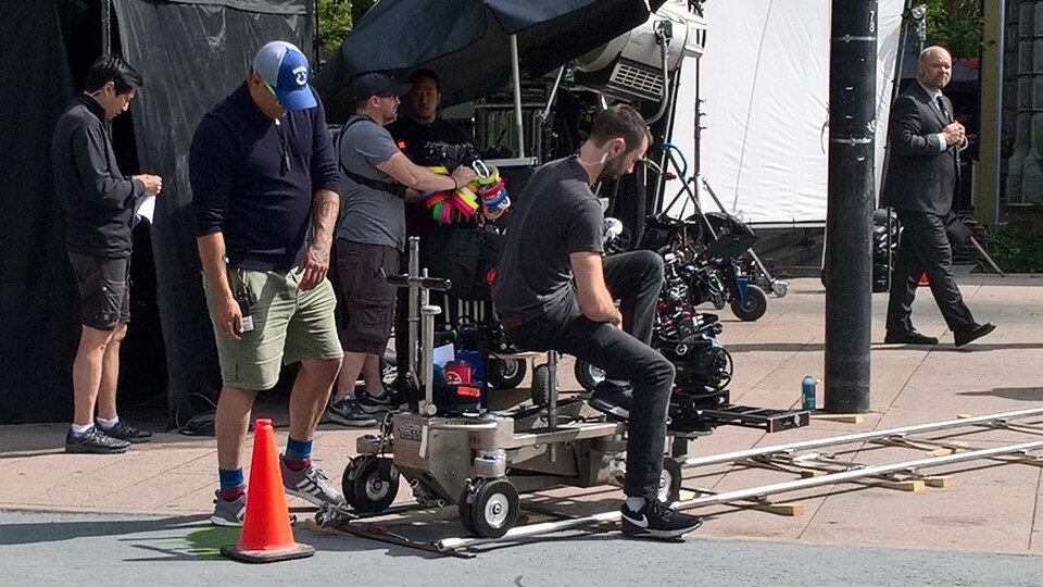 Six personnes sont dehors sur un plateau de cinéma.