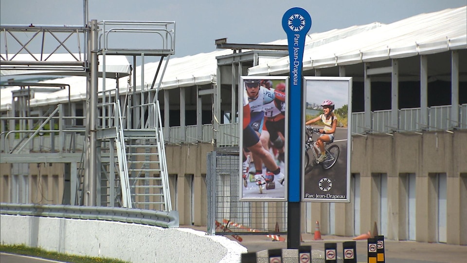 Des affiches montrant une cycliste et des patineurs au circuit Gilles-Villeneuve de l'île Notre-Dame, au parc Jean-Drapeau