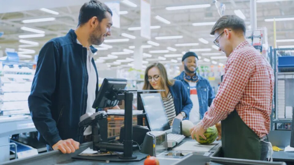 Des clients à la caisse d'une épicerie.