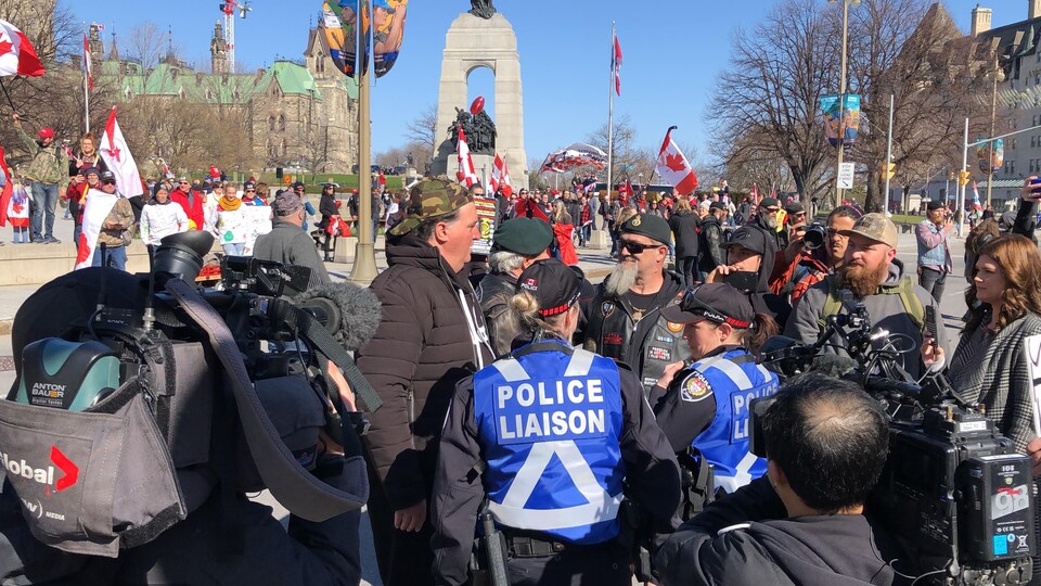 The cameras capture the separation between the demonstration and the counter-demonstration.