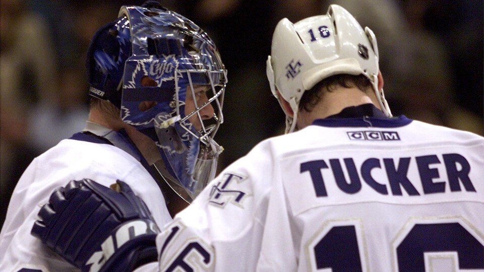 Darcy Tucker congratulates goaltender Curtis Joseph as they both played for the Toronto Maple Leafs in the 2000s.