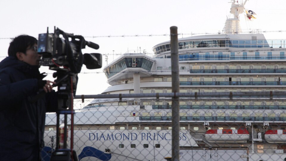 Un caméraman filme le Diamond Princess depuis le rivage.