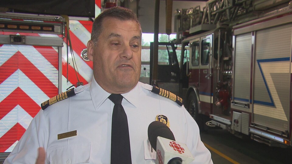 Un homme parle dans une caserne de pompiers.