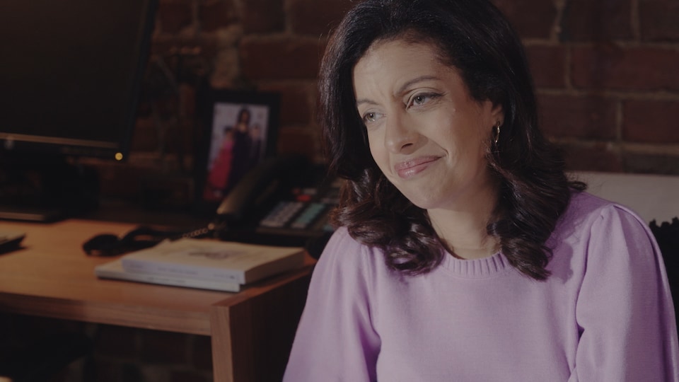 A woman in a purple dress burst into tears.
