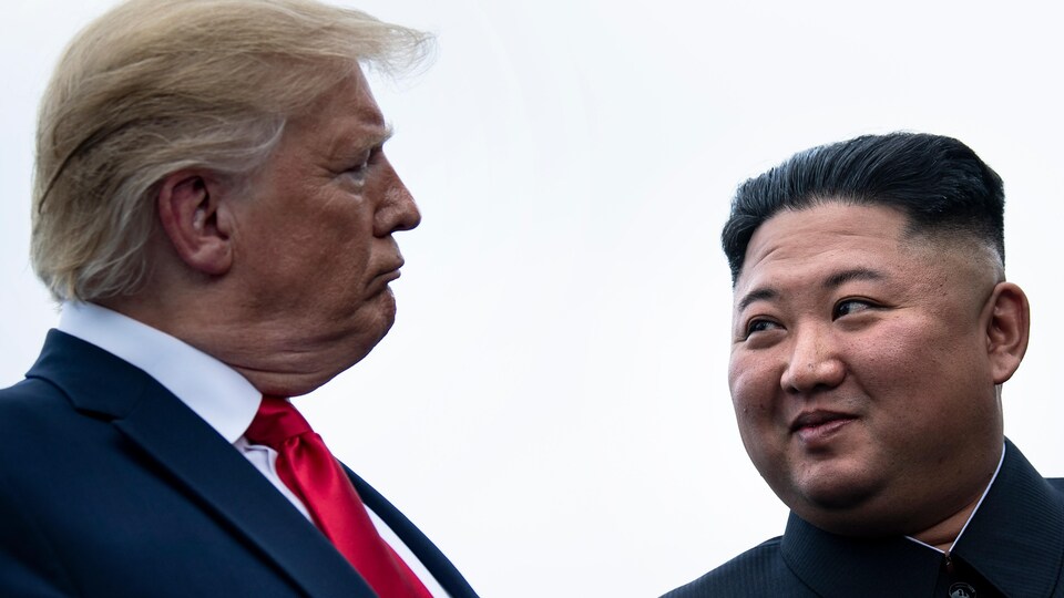 Donald Trump et Kim Jong-un se regardent dans les yeux.