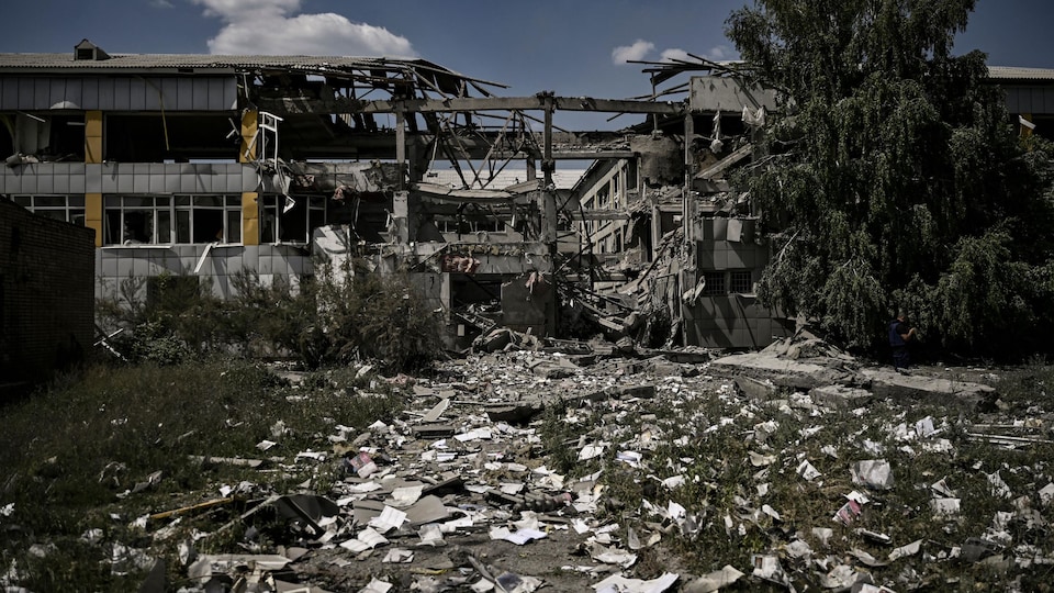A school was destroyed and burnt books were scattered on the ground.