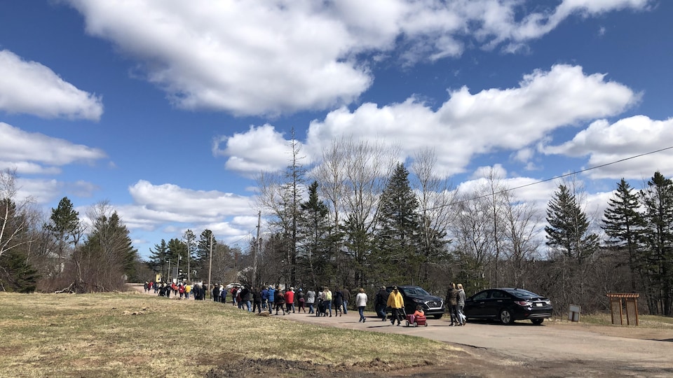 Several people were walking down a street in Dorchester, New Brunswick. 