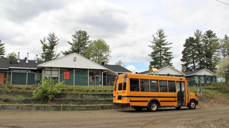 View of the school with the school bus in front.