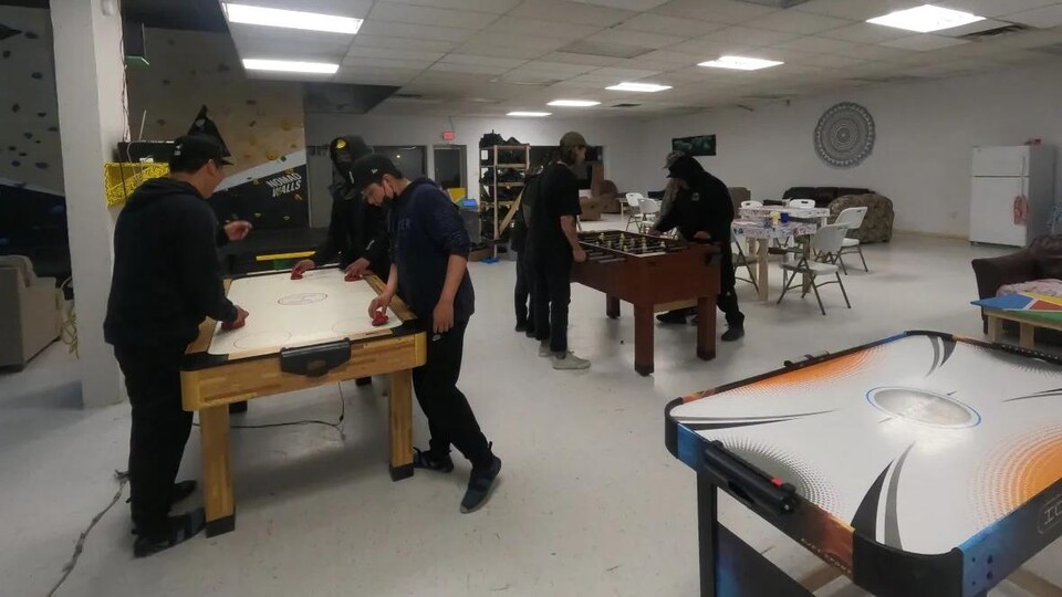 The Cree kids play air hockey and foosball.