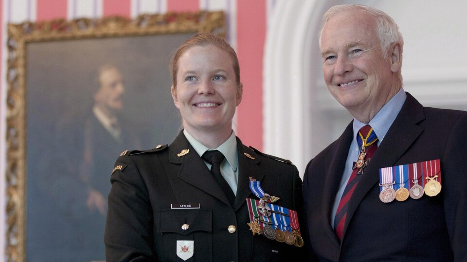 Eleanor Taylor, debout, serre la main du gouverneur général David Johnston.