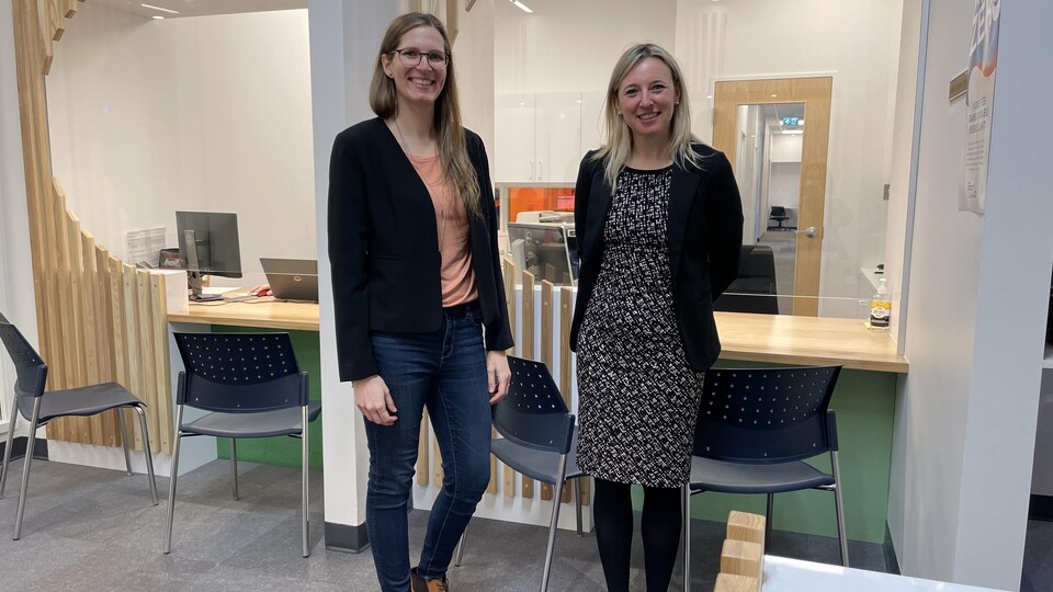 The two standing women smiled.