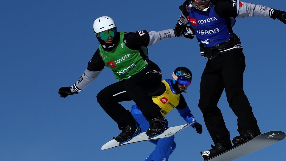 SOLITUDE, UTAH - FEBRUARY 01:   Eliot Grondin of Canada (green bib), Michele Godino of Italy (yellow bib), Baptiste Brochu of Canada (blue heat) and Lucas Eguibar (red bib) compete in the first round of Snowboard Cross Finals of the FIS Snowboard World Championships on February 01, 2019 at Solitude Mountain Resort in Solitude, Utah. (Photo by Ezra Shaw/Getty Images)