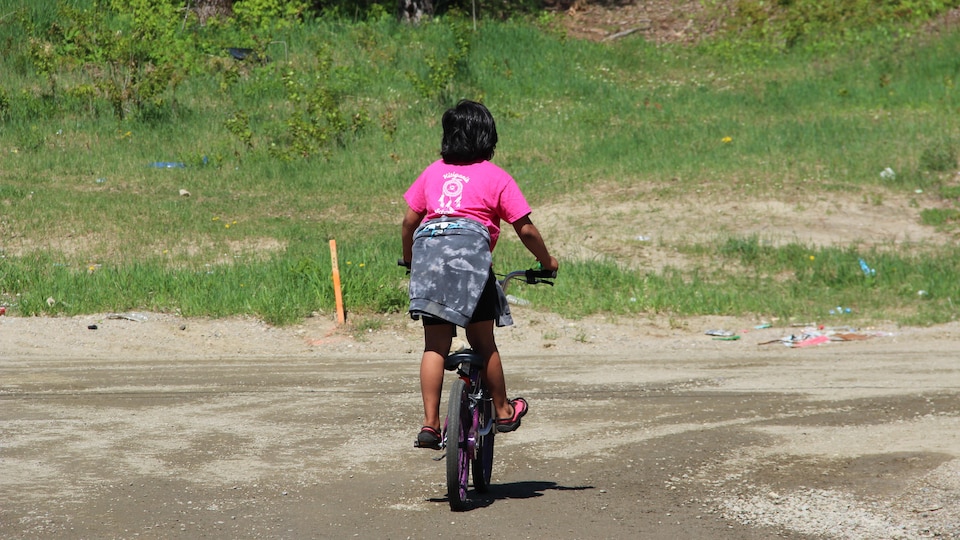 A child on the back bike.