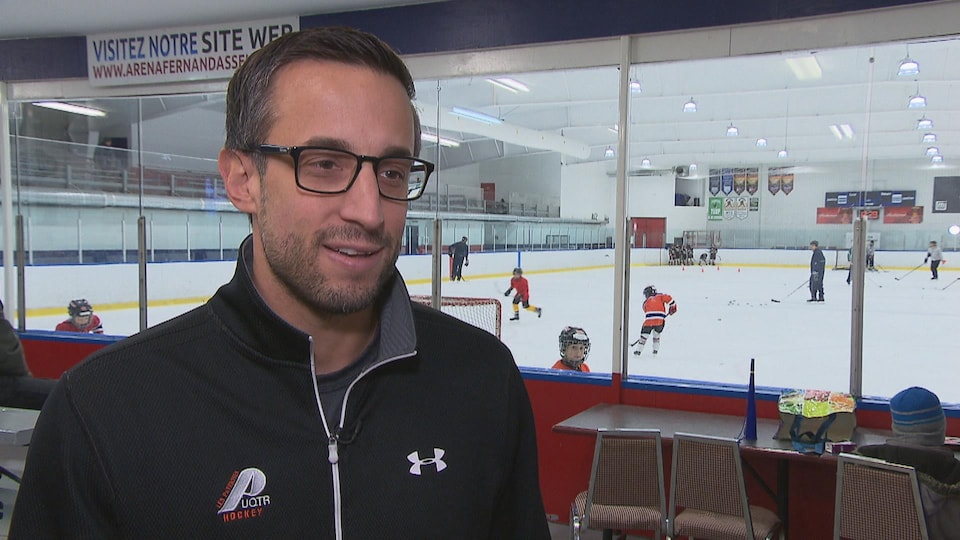 Marc-Étienne Hubert, responsable du programme de hockey des Patriotes de l'UQTR en entrevue dans un aréna.