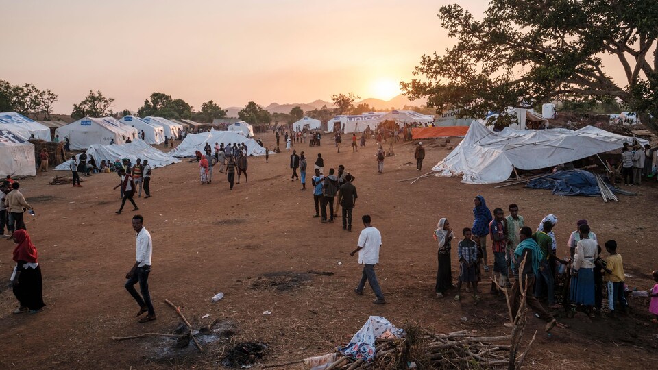 Hundreds of people gathered at a refugee camp. 