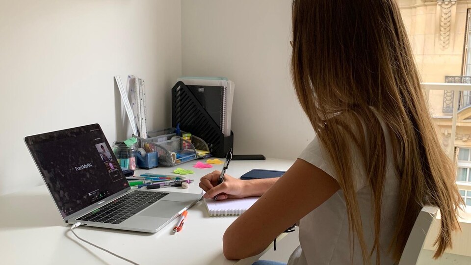 Une jeune femme devant un ordinateur.