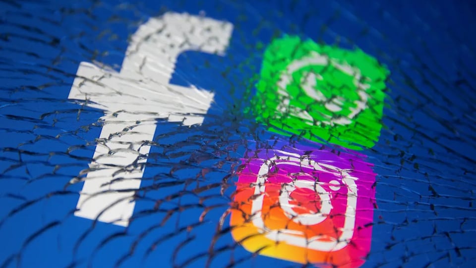 Les applications Facebook, Instagram et WhatsApp sur un écran de téléphone brisé.