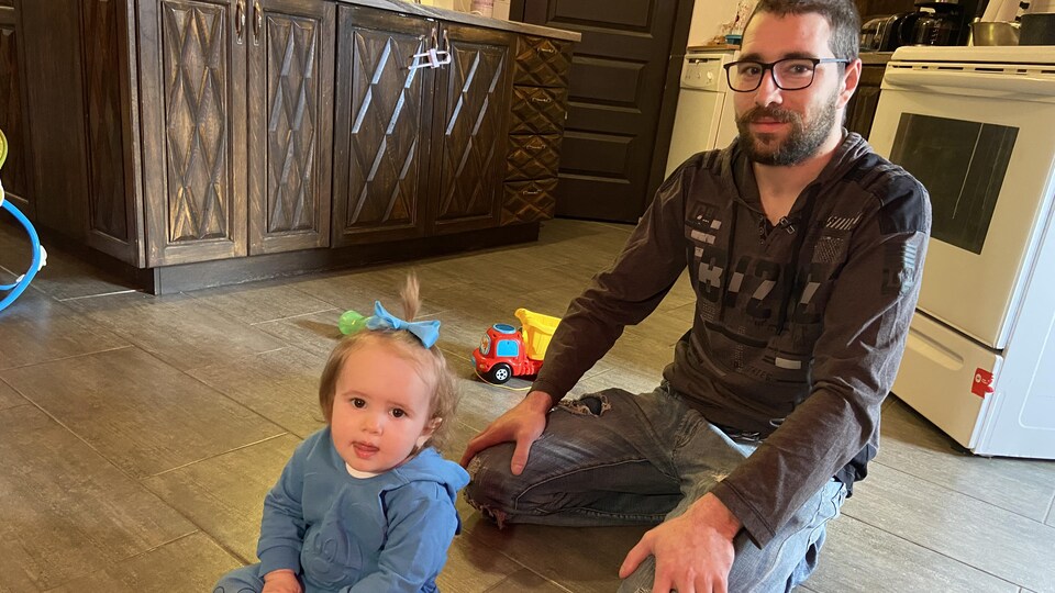 A father is upstairs with his one-year-old daughter.