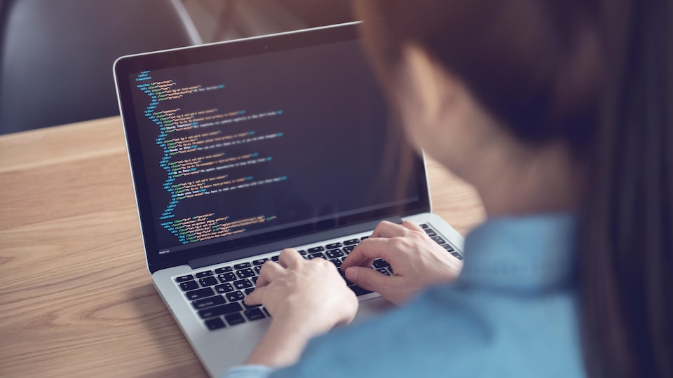 Une femme en train de coder.