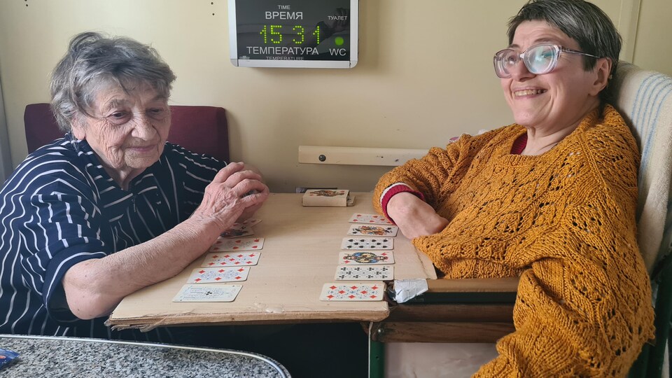 Two women are playing cards.