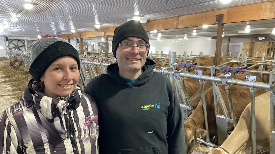 Maxime Plante and Marie-Eve Cyr in front of their cows.