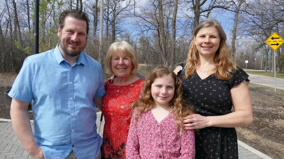 A family standing in Assiniboine Park on May 8, 2022.