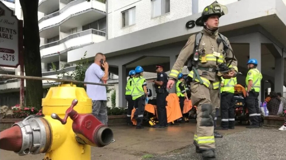 Firefighters and police outside the building.