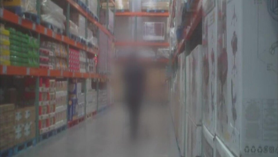 Une figure brouillée dans l'allée d'un magasin à grande surface.