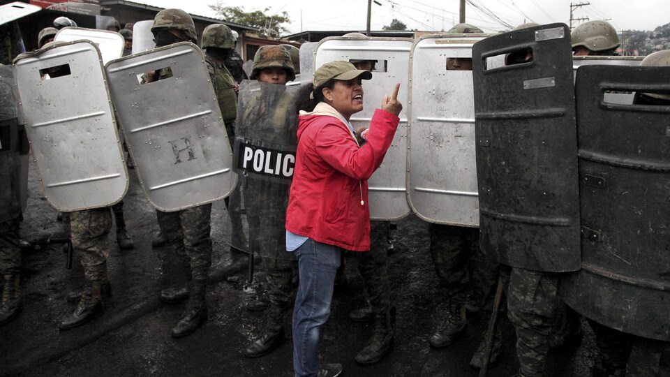 Une femme argumente avec des soldats lors d'une manifestation à Tegucigalpa, au Honduras, le 18 décembre 2017.