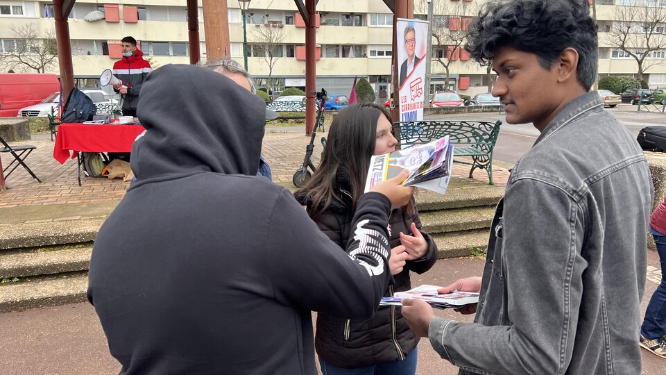 Activists distribute leaflets.