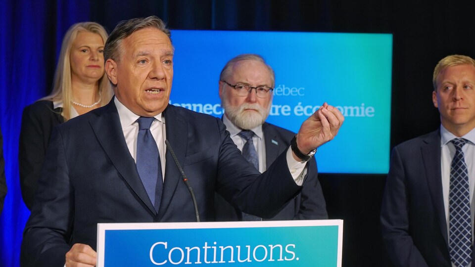 François Legault And Some Of His Candidates At A Press Briefing.