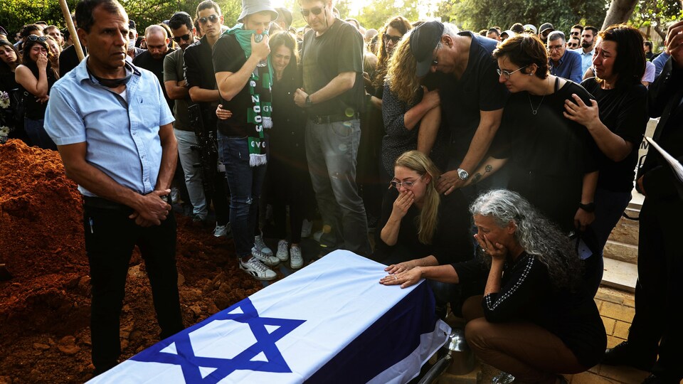 People gather near the coffin of Eitam Megini.