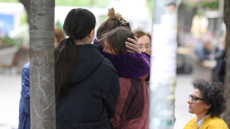 Two women bond to try to comfort each other after tragedy.