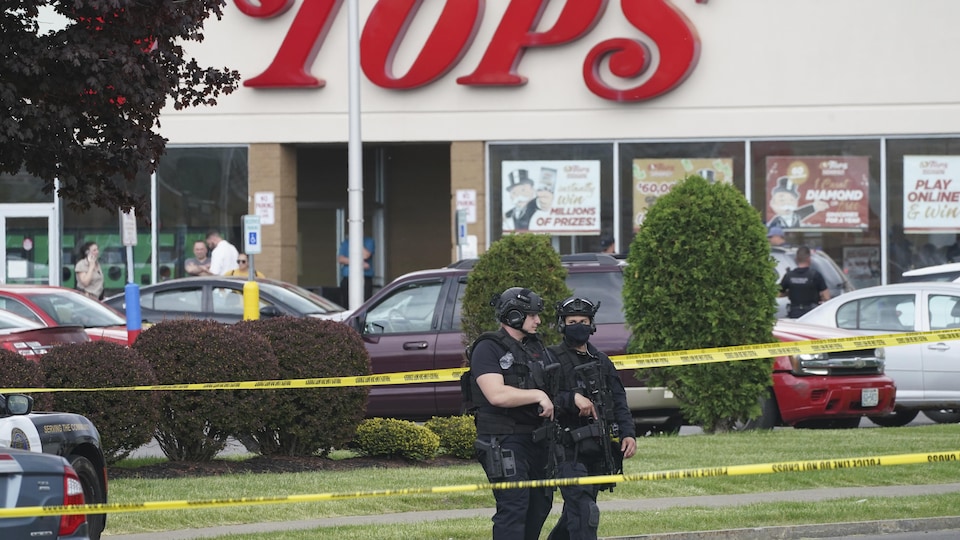 Armed police stand in the yellow round. 