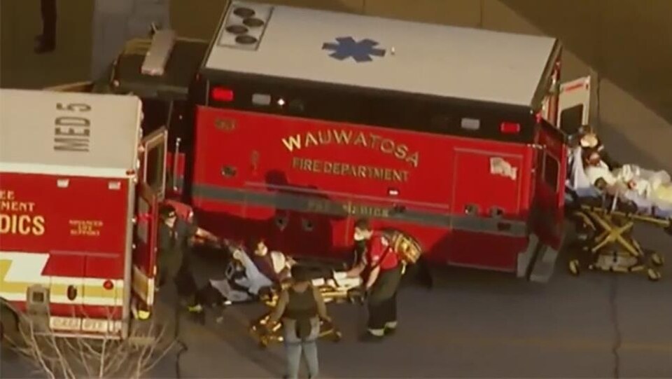 Deux blessés sur des civières à côté de véhicules d'urgence.