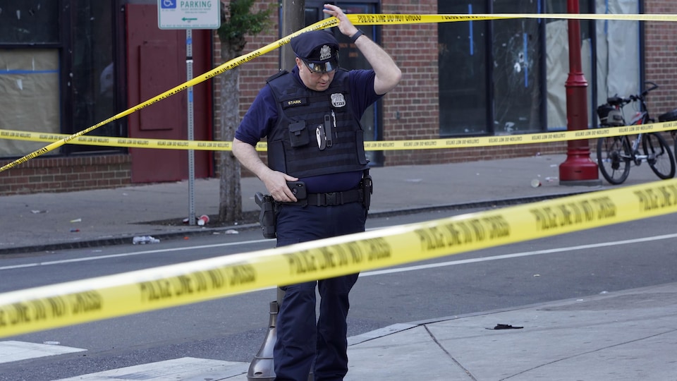A Philadelphia police officer passed under the yellow barrier.
