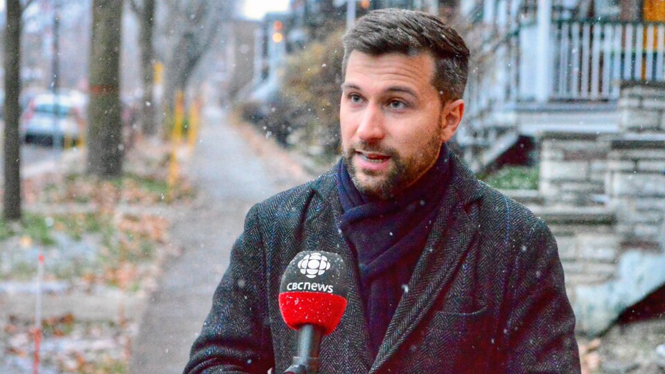 Gabriel Nadeau-Dubois en entrevue à l'extérieur tandis qu'il neige.