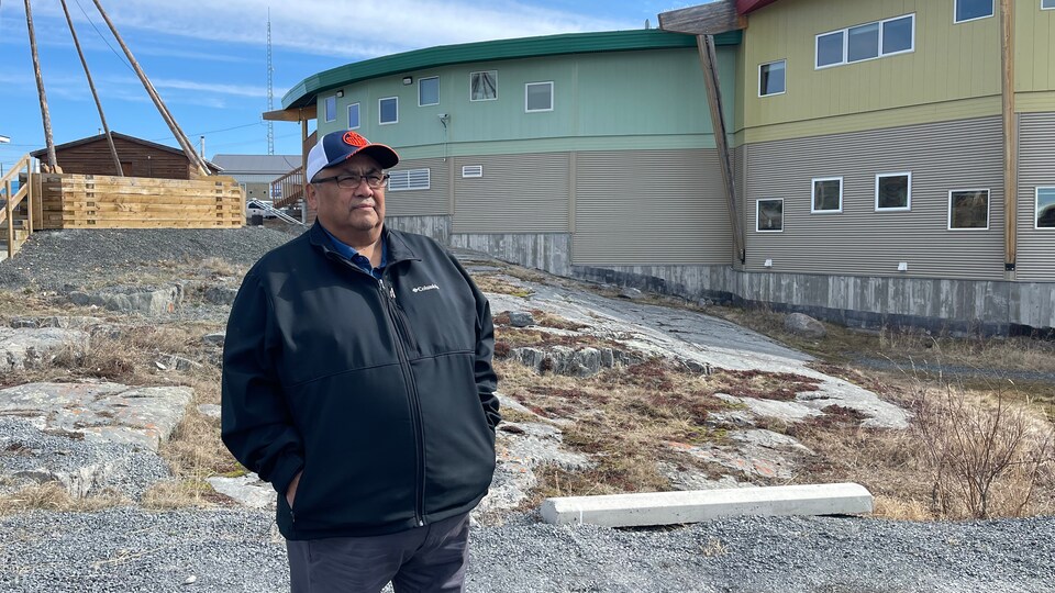 Edward Sangris, Dene Chief of Dettah, southeast of Yellowknife, Northwest Territories, posed in front of the buildings outside, May 2022.