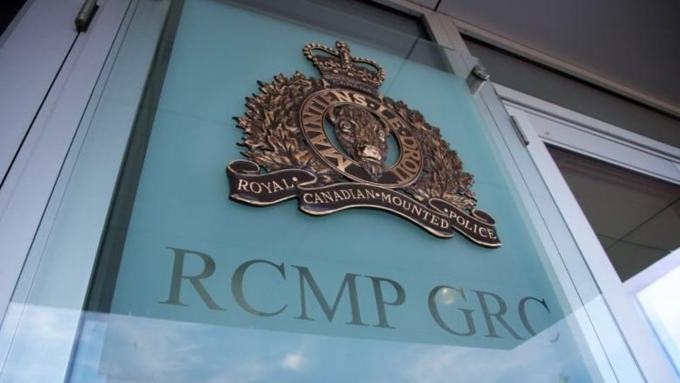 An RCMP logo on a building window.