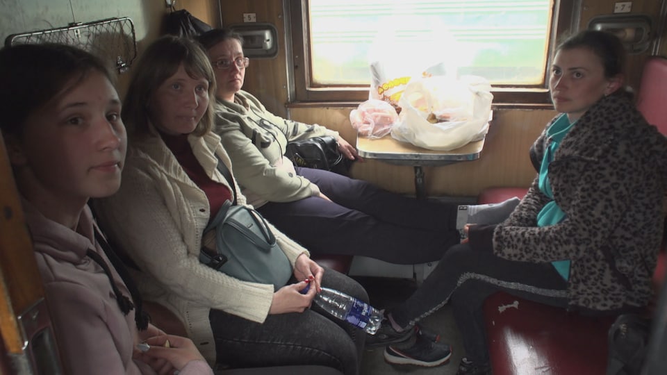 Four women were sitting in a train compartment.