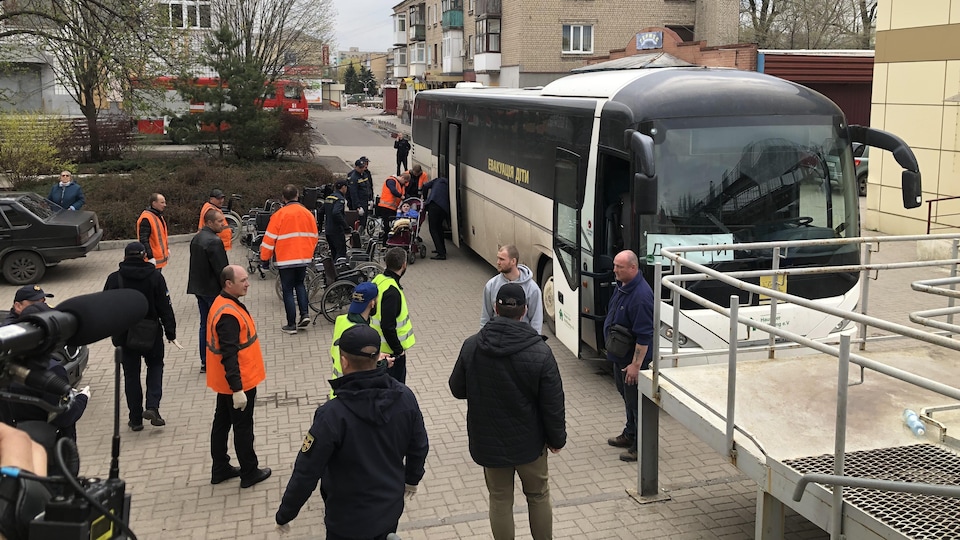 Wheelchairs are placed next to a bus.