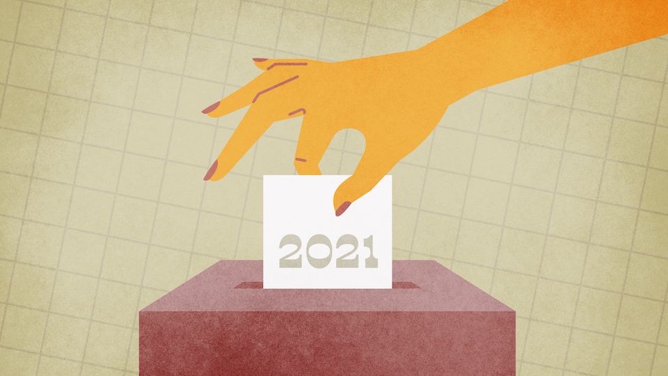 Une main dépose un bulletin de vote dans une boîte.