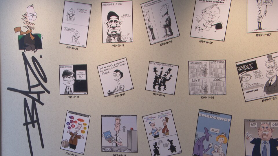 Un assemblage de caricatures exposées sur un mur.