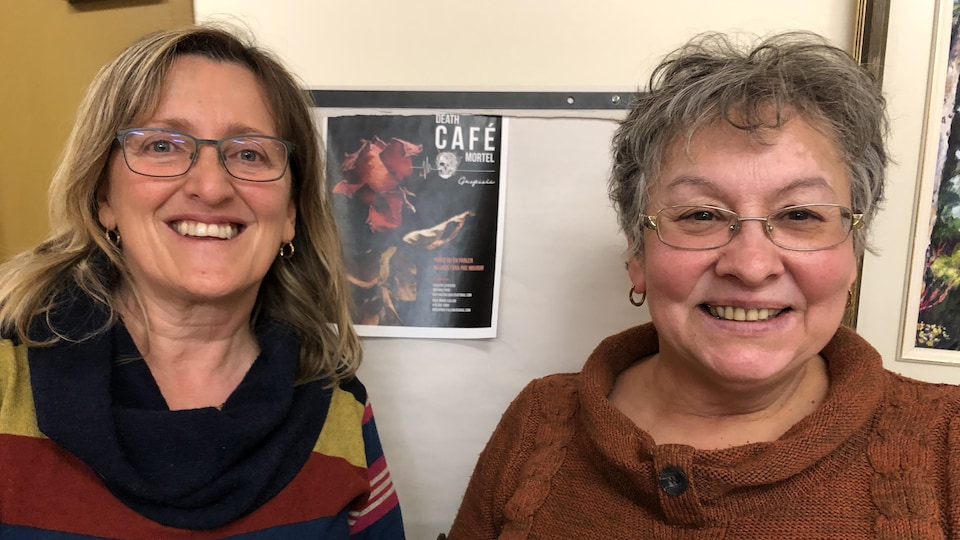 Guylène Lévesque et Rose-Marie Fullum photographiées devant l'affiche du Café mortel Gaspésie.