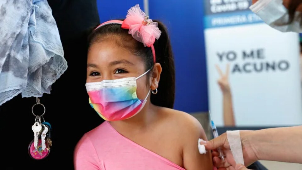 A girl receives a dose of a COVID-19 vaccine at a public school in Chile in September. With Health Canada set to approve Pfizer-BioNTech's COVID-19 vaccine for Canadians aged five to 11, parents of these younger school-aged children must now decide whether they'll be queuing up to get their kids their shots.